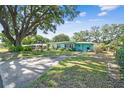Charming single-story home featuring mature tree coverage, lush landscaping, and a well-manicured lawn at 503 Carolyn Dr, Lakeland, FL 33803