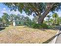 Charming single-story home featuring mature tree coverage, lush landscaping, and a well-manicured lawn at 503 Carolyn Dr, Lakeland, FL 33803