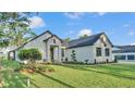 Expansive front yard and exterior view highlight the home's contemporary architectural design at 5087 Cliffside Drive, Lakeland, FL 33813