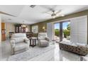 Bright living room with sliding glass doors, tile flooring and comfortable seating arrangement at 538 Eagle Run, Lakeland, FL 33809