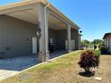 Exterior view showcasing the spacious carport and lush landscaping surrounding the property at 564 Meandering Way, Polk City, FL 33868