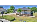Charming home with lush landscaping, a well-maintained lawn, and a convenient circular driveway for easy access and curb appeal at 5706 Manchester W Dr, Lakeland, FL 33810