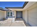 Inviting home entrance featuring a double door, stone tile, address numbers, and a cozy plant to welcome visitors at 5706 Manchester W Dr, Lakeland, FL 33810
