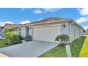 Well-maintained single-story home with a spacious two-car garage and beautiful landscaping at 613 Sarner Pass Way, Winter Haven, FL 33881