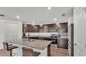 Modern kitchen with granite countertops, stainless steel appliances, and a breakfast bar with seating at 613 Sarner Pass Way, Winter Haven, FL 33881