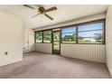 Enclosed lanai featuring walls of windows that provide natural light and views of the yard at 697 Broadmoor Cir, Winter Haven, FL 33884