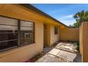 Side view of the home showing the yard space and quaint tiled walkway to the entrance at 697 Broadmoor Cir, Winter Haven, FL 33884