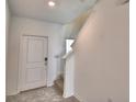 Bright foyer with tile flooring, white trim, and staircase to the upper level offers a welcoming entrance at 752 Reggie Rd, Winter Haven, FL 33884