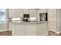 Modern kitchen featuring ample cabinet space, stainless steel appliances, and a center island at 7779 Lake James Blvd, Lakeland, FL 33810