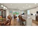 Open concept kitchen overlooking the living room with stainless steel appliances and counter seating at 7779 Lake James Blvd, Lakeland, FL 33810