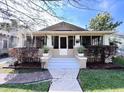 Inviting bungalow-style home with a screened front porch, manicured landscaping, and a paver walkway at 805 Johnson Ave, Lakeland, FL 33801