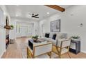 Bright living room featuring a comfortable sofa, modern ceiling fan, and wooden beam accents at 919 S Missouri Ave, Lakeland, FL 33803