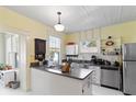 Bright, yellow kitchen featuring stainless steel appliances and tiled backsplash at 934 Lake Elbert Se Dr, Winter Haven, FL 33880