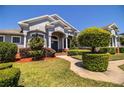 Landscaped front yard featuring manicured bushes and mulched garden beds leading to the entrance at 942 Hanover Way, Lakeland, FL 33813