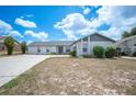 Inviting home featuring an attached garage, well-maintained lawn, and concrete driveway at 3226 Cherry Hill S Cir, Lakeland, FL 33810