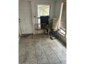 Enclosed porch with tile flooring needs repair and updating at 445 Choctaw Ave, Lakeland, FL 33815