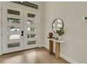 Bright entryway featuring a modern white door with glass panes and a stylish table with decor at 5374 Clubhouse Hills Ln, Lakeland, FL 33812