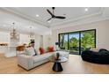 Open-concept living room and kitchen with modern decor, stylish furniture, and a seamless indoor-outdoor flow at 5374 Clubhouse Hills Ln, Lakeland, FL 33812