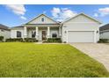 Beautiful home with a well-maintained lawn, brick-paved driveway, and inviting front porch at 6627 Ridgemont Rd, Lakeland, FL 33813