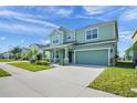 Two-story home boasts a well-manicured lawn, covered entry, and a spacious two-car garage at 871 Fillmore Ct, Davenport, FL 33837