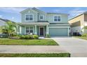 Charming two-story home with a well manicured lawn, covered entry, and attached two-car garage at 871 Fillmore Ct, Davenport, FL 33837