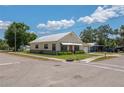 Single-story home with a metal roof and attached garage; street view showing the grassy corner lot at 101 S Cleveland Ave, Fort Meade, FL 33841