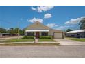 Single-story home with manicured lawn, small walkway, attached garage, and light-colored siding at 101 S Cleveland Ave, Fort Meade, FL 33841