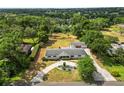 Expansive aerial view showcasing the home's large lot, mature trees, and circular driveway, creating a peaceful retreat at 1205 Rolling Woods Ln, Lakeland, FL 33813