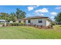 Well-maintained single-story home with a landscaped front yard and healthy green grass in a residential neighborhood at 1433 Ellison Ln, Lakeland, FL 33801