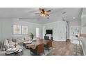 Bright living room with wood floors, ceiling fan, and modern furniture, offering a stylish and comfortable space at 1520 Caroline Ct, Bartow, FL 33830