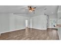 Open floor plan with hardwood floors and ceiling fan at 1520 Caroline Ct, Bartow, FL 33830