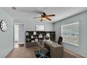 A cozy home office featuring a built-in bookcase, desk, a ceiling fan and a window at 1520 Caroline Ct, Bartow, FL 33830