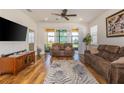 Cozy living room with hardwood floors, plush sofas, and sliding glass doors to the lanai at 1620 Linz Ct, Winter Haven, FL 33884