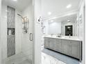Modern bathroom with a glass-enclosed shower, double vanity, and stylish tile accents at 203 N Sweetwater Blvd, Longwood, FL 32779