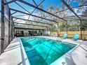 Enclosed pool area showcasing a sparkling in-ground pool and an outdoor seating area for entertaining at 203 N Sweetwater Blvd, Longwood, FL 32779