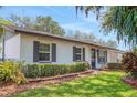 Charming single-story home with lush lawn and mature landscaping at 209 S Hydrangea Ave, Polk City, FL 33868