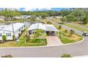 Scenic aerial view of home with lush landscaping, covered carport, and peaceful pond nearby at 2101 Cypress Cross Dr, Lakeland, FL 33810
