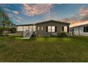 Inviting home with well-maintained lawn, enclosed porch, and fresh exterior paint for a modern look at 2101 Cypress Cross Dr, Lakeland, FL 33810