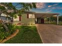 Charming home featuring a covered carport, beautifully landscaped front yard, and a freshly painted exterior at 2101 Cypress Cross Dr, Lakeland, FL 33810