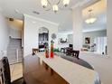 A dining room with a large table and views to the living room and kitchen offers space for meals at 2112 Betsy Ross Ln, St Cloud, FL 34769