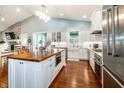 Spacious kitchen features white cabinetry, stainless steel appliances, and wood flooring at 2115 W Pipkin Rd, Lakeland, FL 33811