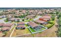 Wide aerial view of a home and the surrounding neighborhood showcasing numerous clay tiled roofs at 2277 Bella Luna Cir, Lakeland, FL 33810