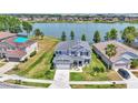 Stunning aerial view of a two-story home with a large backyard and serene lake views in the background at 2468 Winnipeg Dr, Lakeland, FL 33805