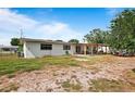 Spacious backyard featuring a covered patio area and ample open space at 2520 Avenue C Sw, Winter Haven, FL 33880