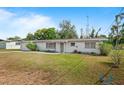 Quaint single-story home featuring a clean white exterior and a front yard at 2520 Avenue C Sw, Winter Haven, FL 33880