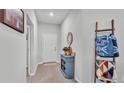 Inviting entryway with a blue console table, decorative mirror, and coat rack for a cozy feel at 2611 San Marco Way, Winter Haven, FL 33884