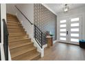 Inviting foyer with staircase and patterned wallpaper feature at 2645 Delphi Hills Ct, Lakeland, FL 33812