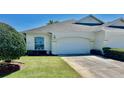 Charming single-story home with a well-maintained lawn and a two-car garage at 2820 Prestwick Dr, Lakeland, FL 33803