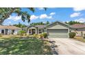 Inviting home with a two-car garage, manicured lawn, and stylish exterior at 3252 Bellflower Way, Lakeland, FL 33811