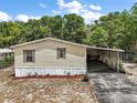 Charming single story home boasting a covered carport and an airy, spacious front yard at 36912 Skycrest Blvd, Fruitland Park, FL 34731